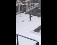Guy jump ropes on rooftop during blizzard  