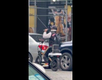 Man rides bike does karaoke at road