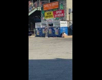 Guy climbs inside blue clothing donation bin 