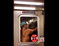 Shirtless man with blue bonnet on train