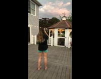 Black shirt girl takes photo of sunset