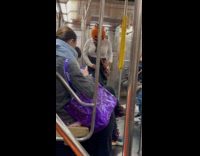 Couple as pumpkin heads on subway 