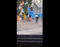 Woman onesie twerk beside guy sit chair