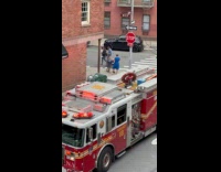 Man propose on street near fire truck