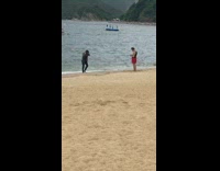 Black pants guy jump spins beach sand  