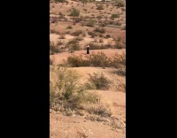 Woman shiny black dress dance desert baby