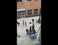 Collab VIBES - Guy stands arms out wind tornado school