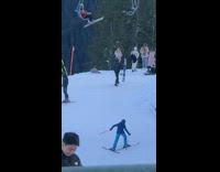 Woman in white top poses at the snowy mountain