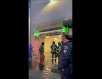 Firefighters look at pipe burst at subway