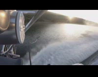 Guy short wetsuit pulled by boat