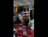 Elderly woman dragging cart with stand underneath
