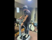 Man vibrating on top of exercising equipment on max power