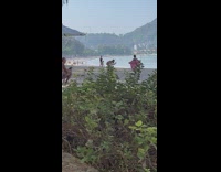 Woman with pink shirt walk on beach