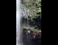 Woman yoga pose with waterfalls in front