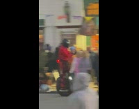 Man in red jacket takes video while on the Monowheel