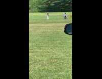 Girl white pants raise arm feet park