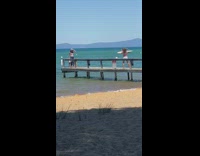 Blue pants girl lake wood dock friend