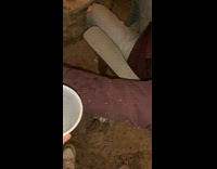 Guy pours plastic cup of water onto friends waterproof jacket