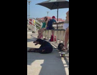 Woman in green bikini selfie beside two kids