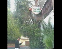 Guy photographs person outside of restaurant 