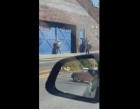 White shirt girl poses blue barn door 