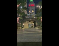 Woman in white sweater tiktok dance park walkway