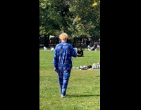 Collab WINY - Man wearing onesie strolling through central park 