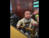 Baby fed empty spoon excited and happy