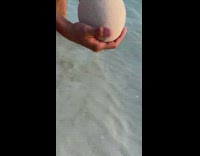 Guy puts sand egg in water 