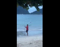 Man red shirt beach photo with tripod