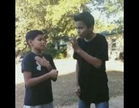 Boy makes coin disappear after fist pump magic trick, makes it appear behind ear