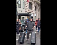 Man playing song on speakers at hands off protest 