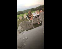 Girl pretends to drink white cup outdoors