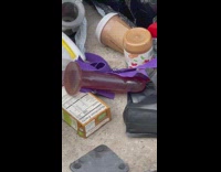 Purple toy with pile of trash sidewalk 