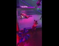 girl in pink outfit under stairs neon sign