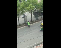 Green safety vest guy sweeps road pt. 2 
