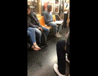a man draws a sketch on subway train