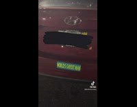 Red car with a bunch of stickers on it 