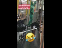 Man in green morphe suit dances by himself on the subway