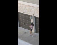 Girl shirt tied on back dance garage gate