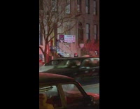 Lady dances on steps by parked ambulances 