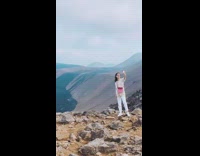 Woman white sweater sunglasses selfie volcano lava flow