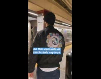 Guy wears same bomber jacket and beanie as another guy in subway station