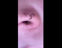 Girl draws face on side of nose