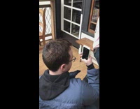 Guy poses with two emmy trophies pink