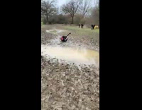Guy tries to jump over puddle fail 