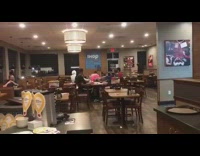 Guy pink shorts blue pool noodle dives across ihop table restaurant