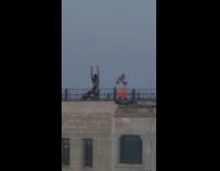 Woman printed skirt move arms around rooftop