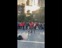 Two guys red shirt fight each other with boxing gloves in front of singing Amish choir 