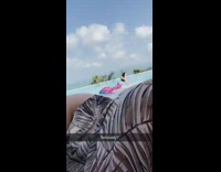 Woman with blue pink mermaid tail on pool